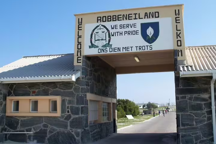 Entrance to Robben Island with a welcome sign, highlighting the historic significance of the island museum tour.