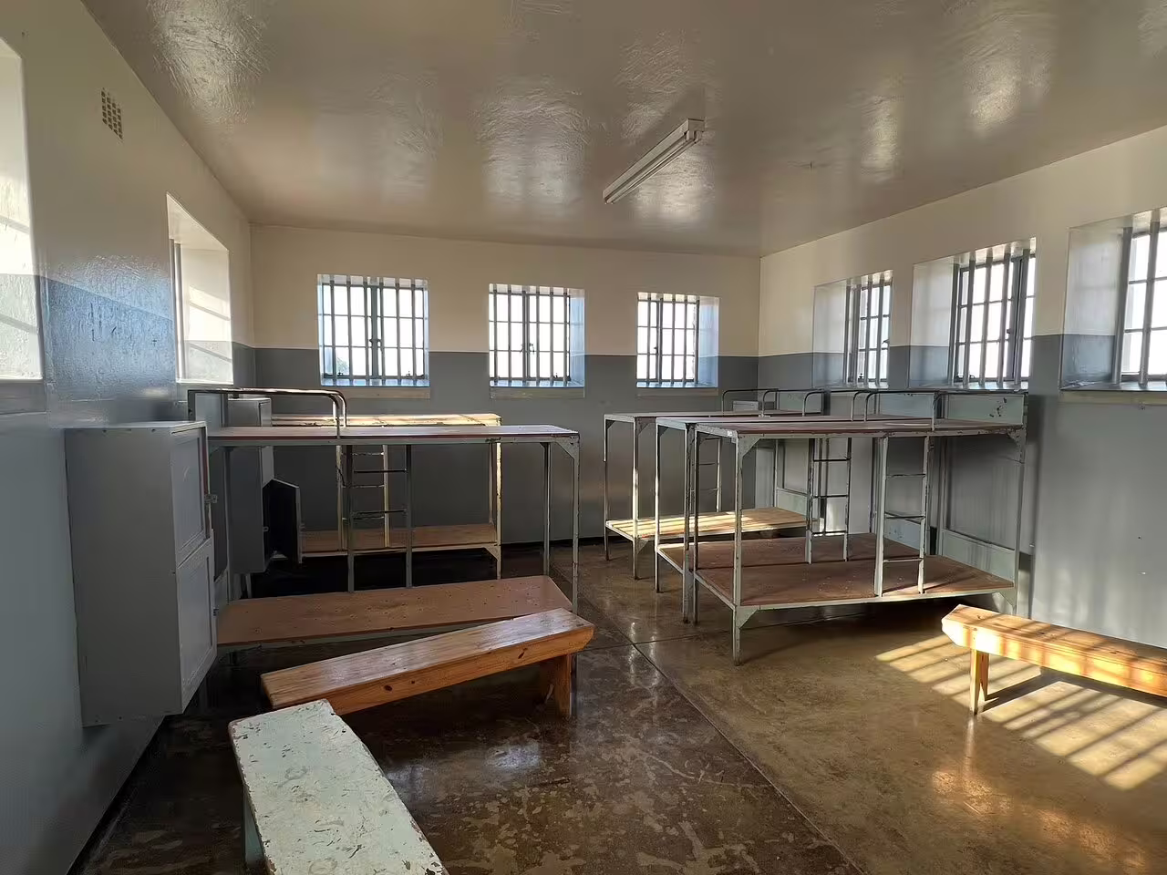 Explore the historic prison cell block on a Robben Island Museum ferry tour with hotel transfer.