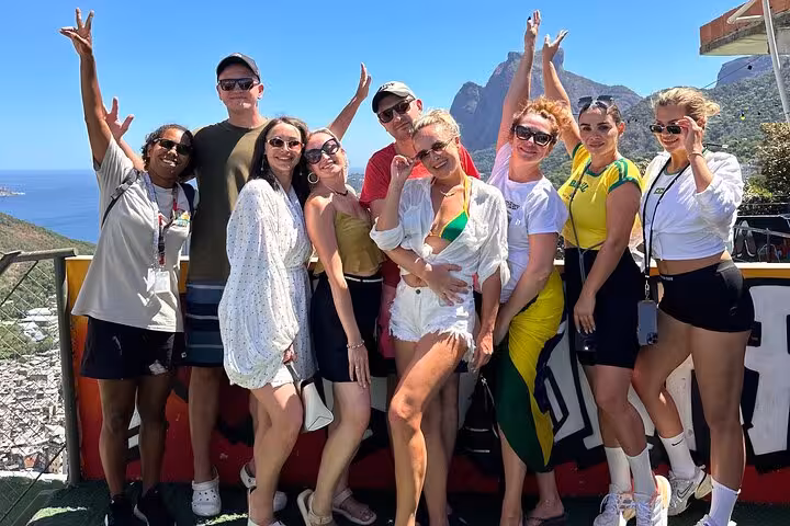 Group of tourists enjoying a sunny day with scenic views on Rocinha tour, the largest favela in Latin America.