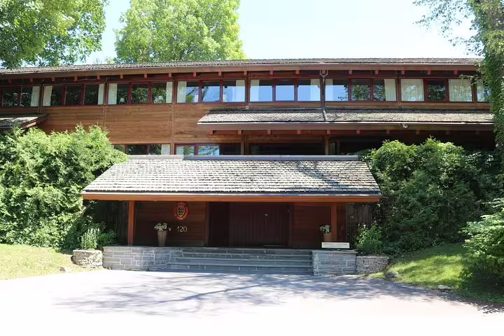 Historic wood and stone mansion with curved roofline in Rockcliffe Park Ottawa neighborhood