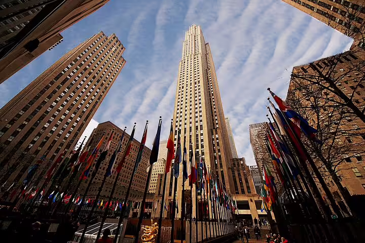 Rockefeller Center tower surrounded by international flags with Art Deco skyscrapers in Midtown Manhattan