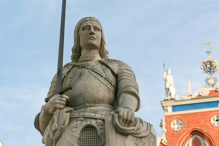 Stone statue of Roland holding a spear and shield in Riga's Town Hall Square