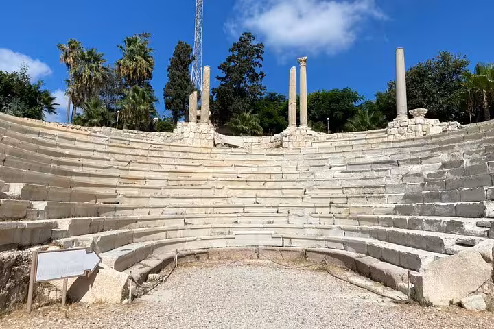 Roman amphitheater of Kom El Deka in Alexandria on a private historical guided day tour from Cairo, under blue skies