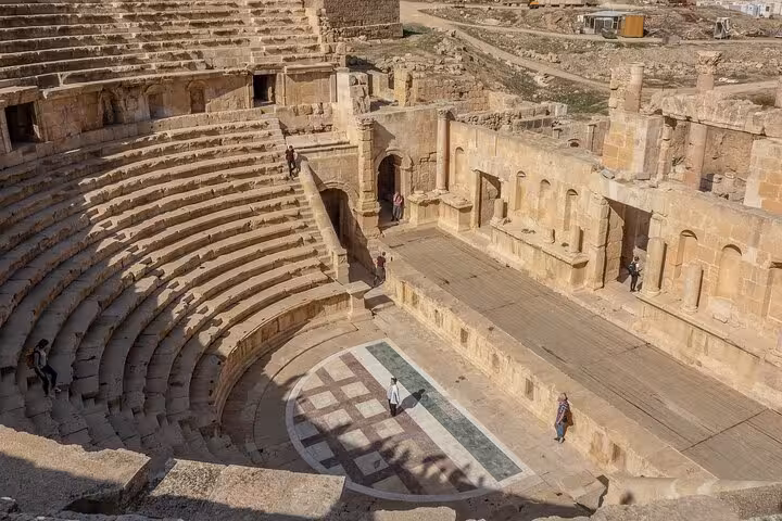 Ancient Roman amphitheater seating and stage ruins, cultural highlight on Rome walking tour itinerary