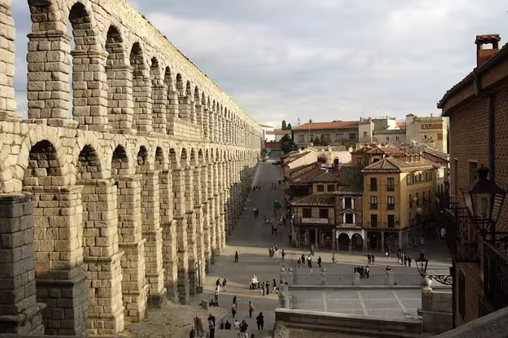 Roman Aqueduct of Segovia towering over the old town on a private minivan tour from Madrid, iconic landmark