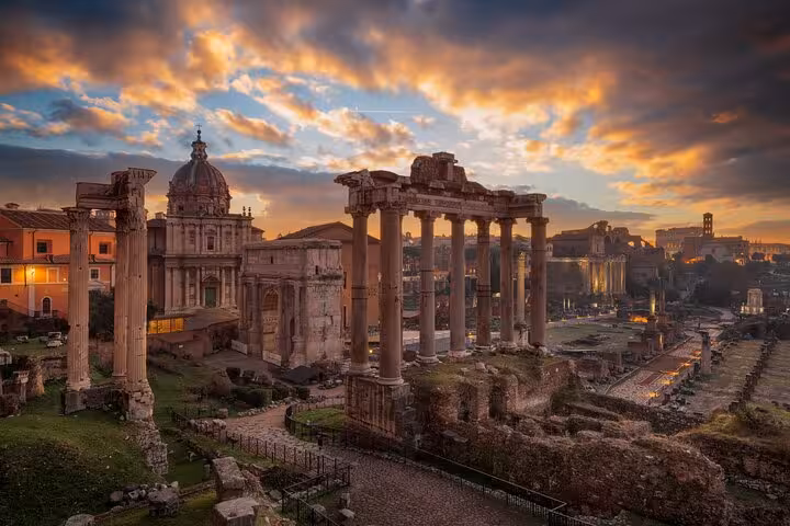 Roman Forum at sunset with ancient columns in Rome, featured on a self-guided Colosseum, Palatine Hill and Forum tour