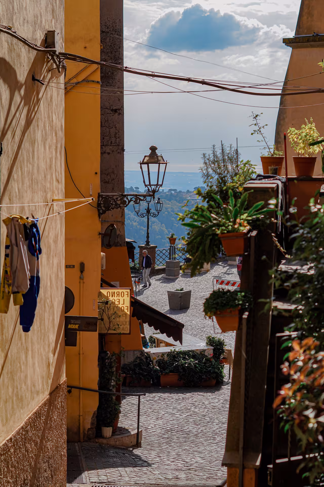 Picturesque alley in Italian village with scenic views and lush greenery on the Roman Hills Vintage Fiat 500 Tour.