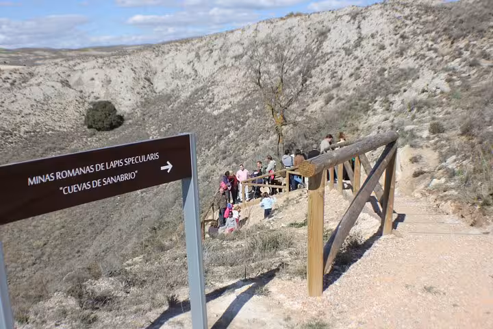 Trail and sign to Roman Lapis Specularis Mines Cueva de Sanabrio, visitors on guided hike in Cuenca