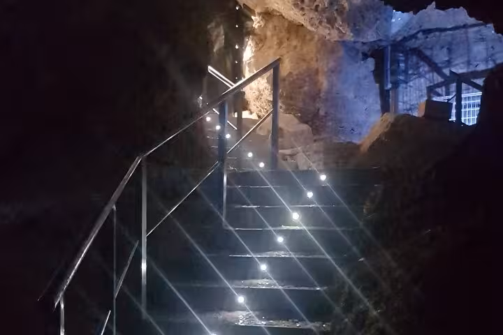 Illuminated staircase inside Roman Lapis Specularis mines, showing access tunnel on guided underground tour
