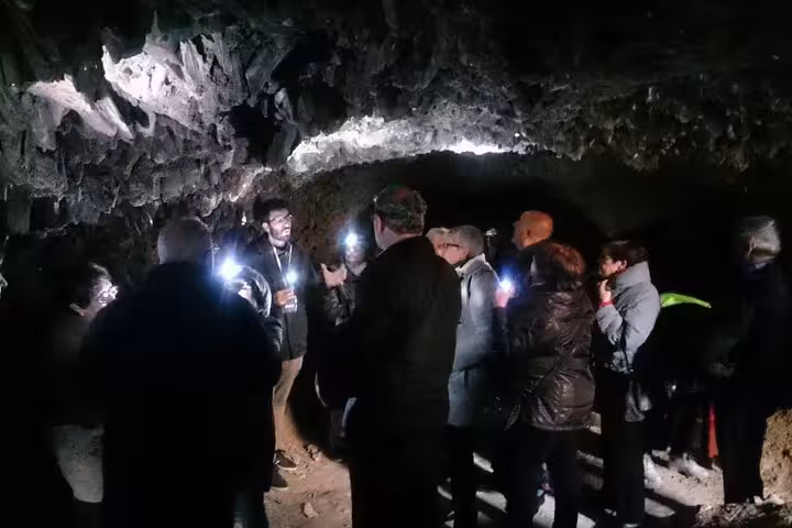 Guided night-style exploration inside Roman Lapis Specularis Mines with headlamps, learning Roman mining history
