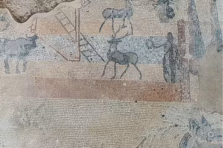 Close-up of Roman mosaic with horses and figures, a highlight of the Roman Empire day tour from Madrid
