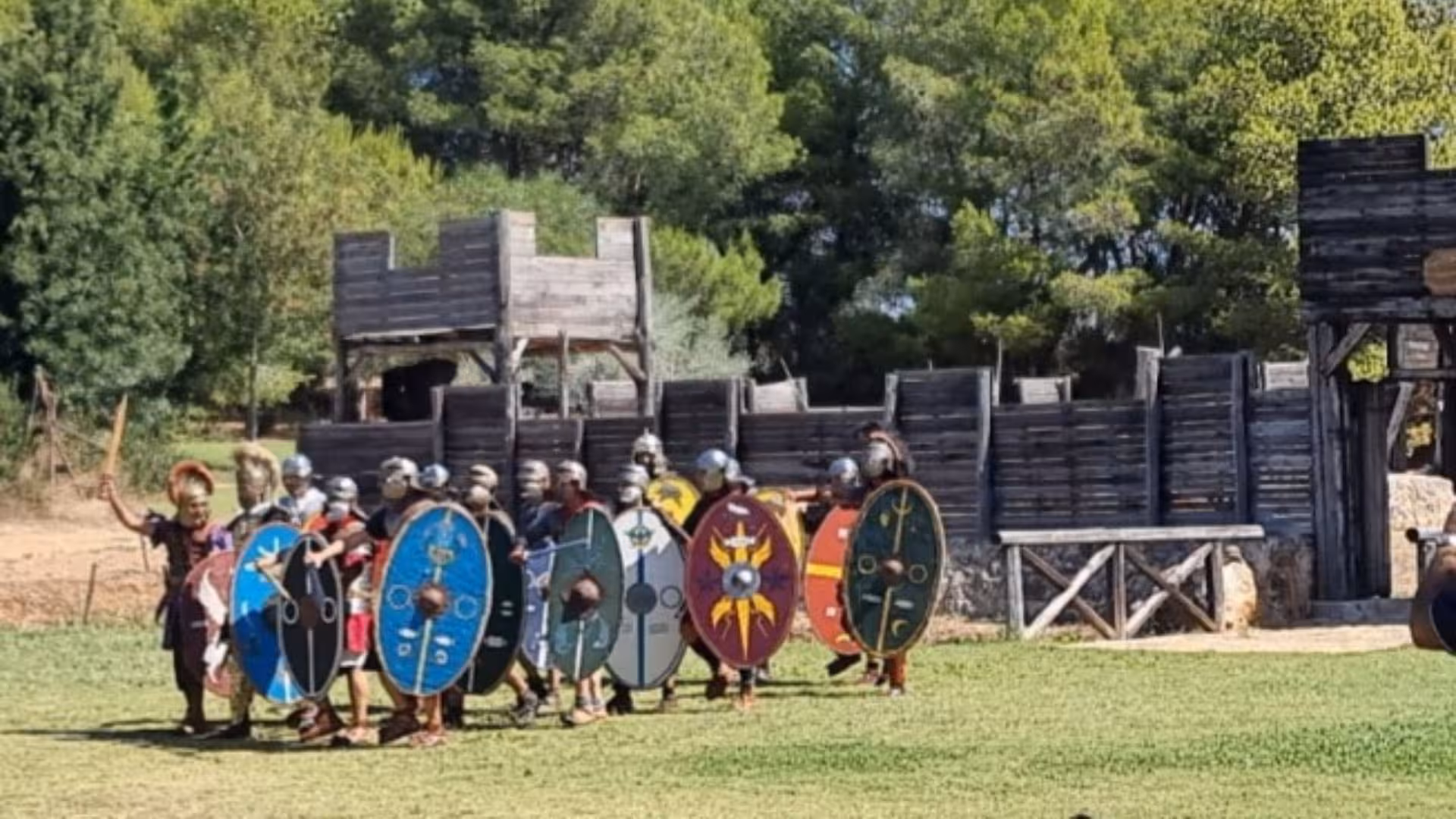 Group of Roman soldiers with shields march near the reconstructed Roman Castrum in Sassari.