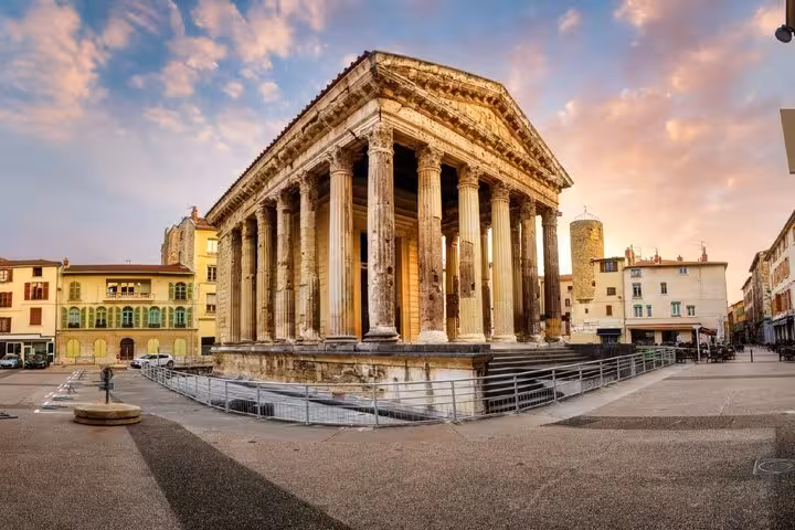 Ancient Roman temple with Corinthian columns in Vienne France town square at sunset