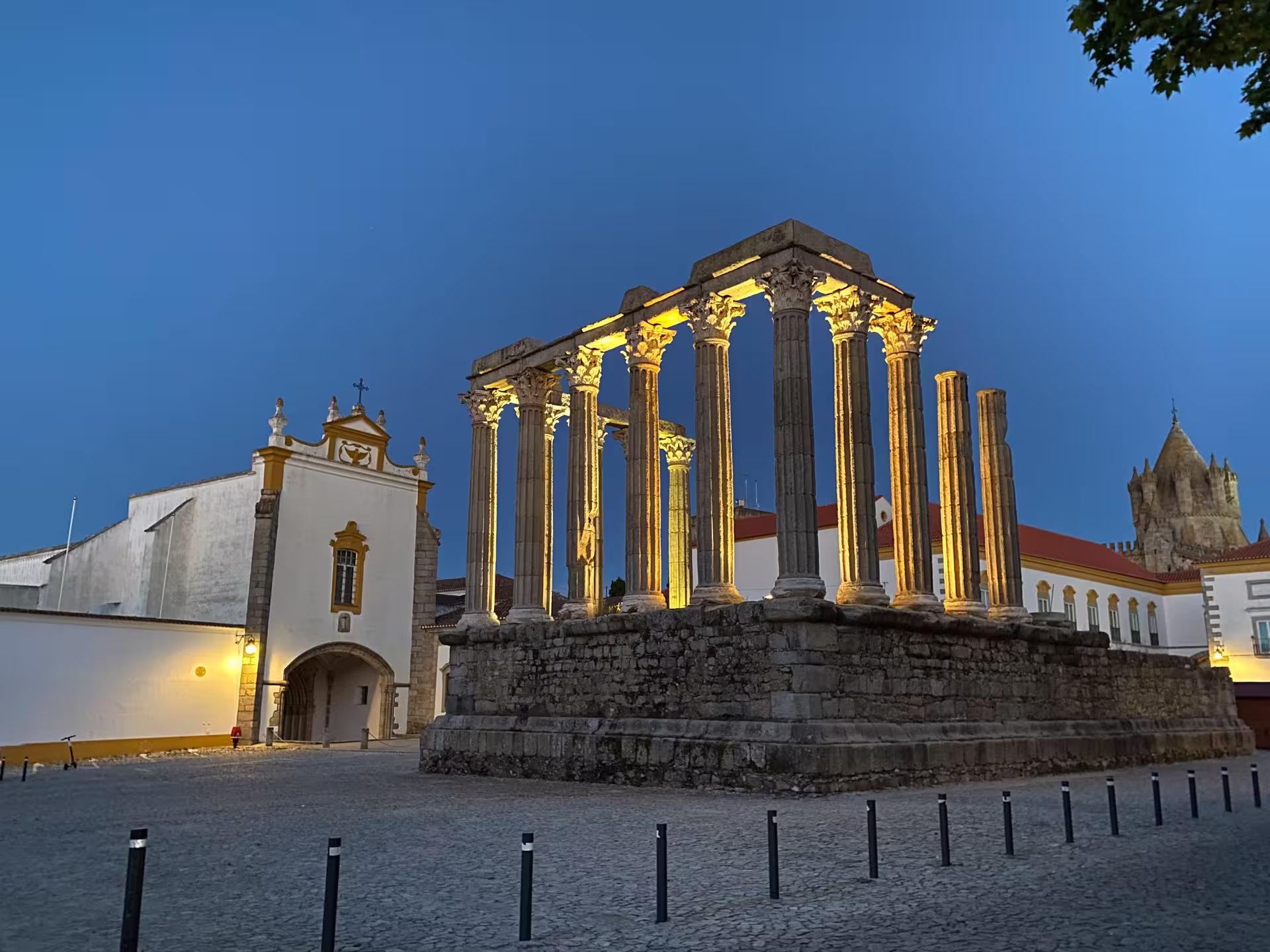 Illuminated Roman Temple of Évora at twilight, showcasing ancient architecture and cultural heritage of Alentejo, Portugal.