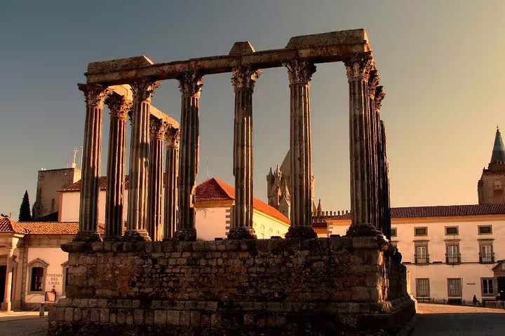 Ancient Roman Temple in Évora, Portugal, basking in golden sunlight, featured in a private full-day tour from Lisbon.