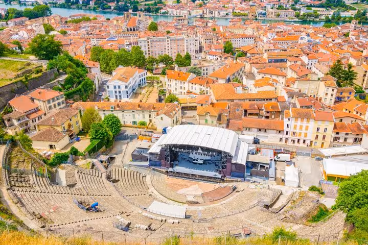 Aerial view of ancient Roman theatre in Vienne France with stage setup and red-roofed city behind
