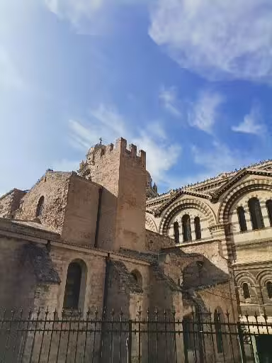 Romanesque cathedral facade in Provence under blue skies, a highlight of a 7-day Christian heritage and cultural tour