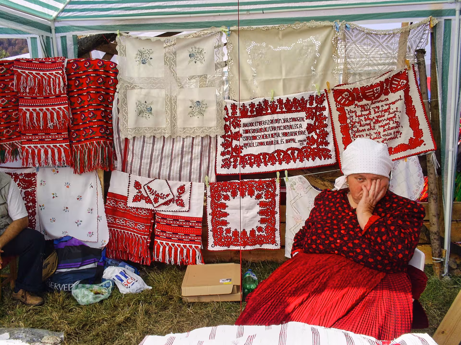 Traditional Romanian hand-embroidered textiles displayed at a vendor stall during Negreni Flea Market guided tour