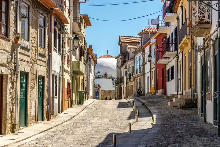 Charming cobblestone street lined with colorful buildings in historic Porto neighborhood
