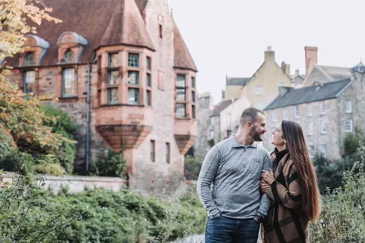 Romantic couple poses near Dean Village, capturing the charm and history of Edinburgh.