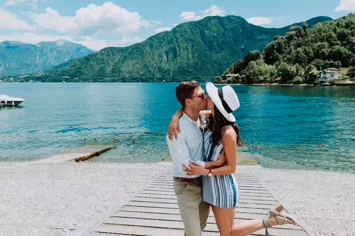 Romantic couple kissing on Lake Como beach, private tour with personal travel photographer in Italy