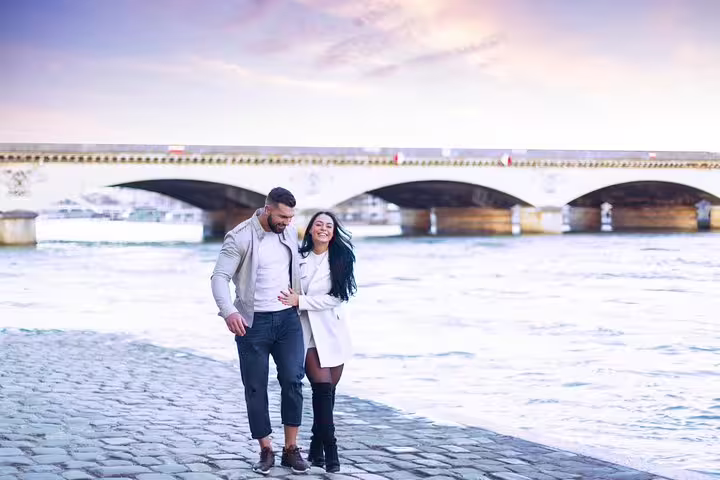 Romantic couple walking along the Seine near Pont Neuf, Paris engagement photo session with proposal photographer