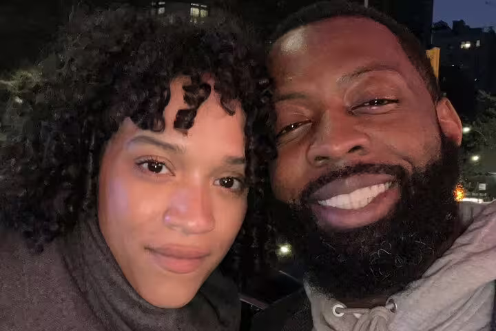 Couple taking a selfie together at night in NYC during a romantic walking tour