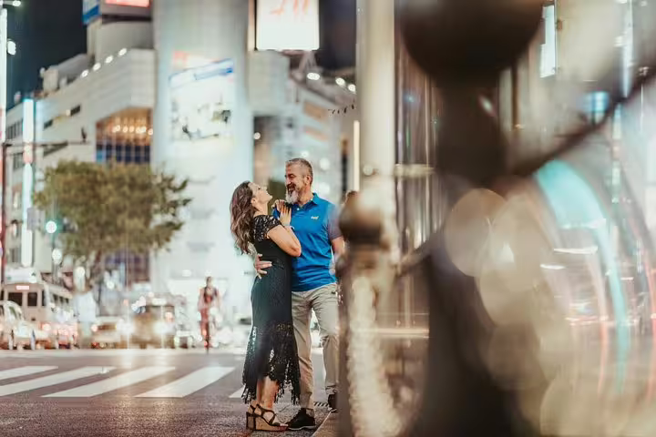 Romantic couple photo shoot on a Tokyo night street with bokeh lights, private travel photographer tour session