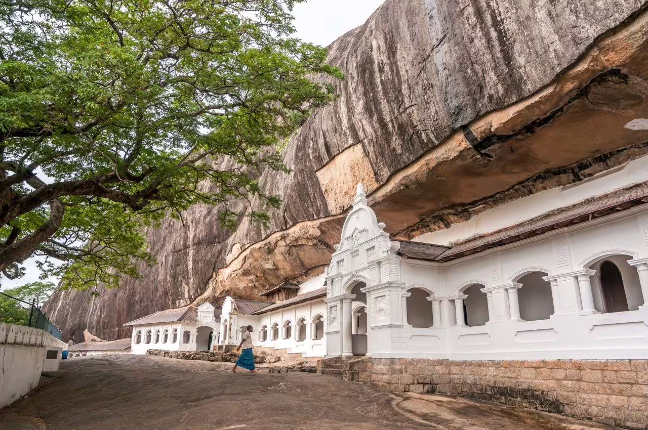 Scenic view of ancient rock temple nestled in lush greenery, ideal for a romantic escape private tour.