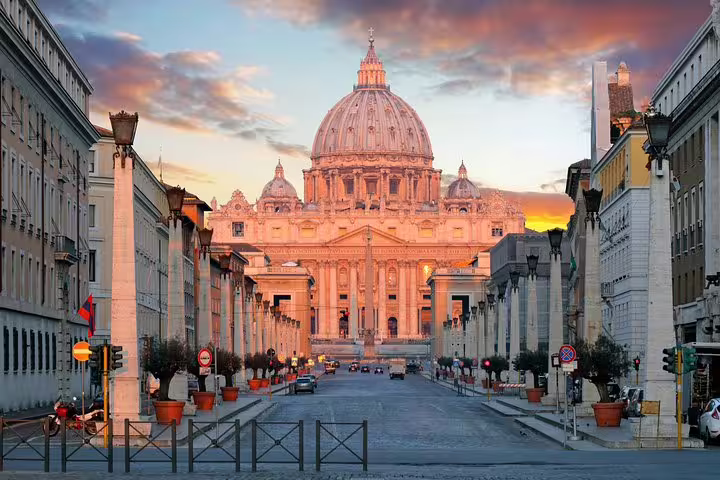 Sunset view of St. Peter's Basilica from a street in Rome, ideal for an Italian aperitivo foodie tour with Vatican vistas.