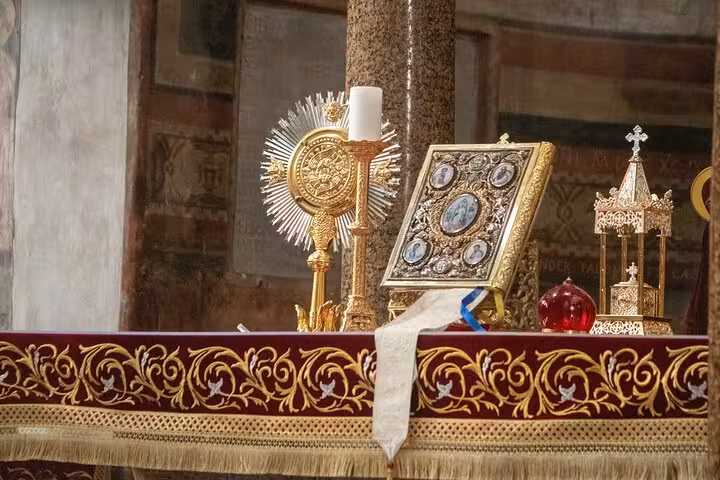 Close-up of ornate religious artifacts on an altar, part of a private exploration tour in Rome's historic churches.