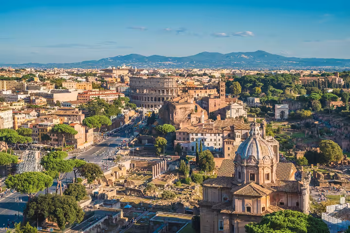 Panoramic view of Rome with the Colosseum, Roman Forum and domed churches, explored on The Rome You Don’t Know taxi city tour