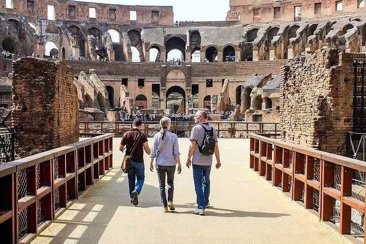 Small group with private chauffeur walking inside Rome Colosseum arena on exclusive two days skip the line tour
