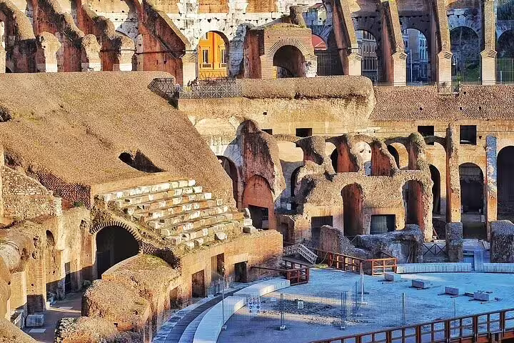 Close-up of ancient underground chambers and seating inside Rome Colosseum on guided skip the line chauffeured tour
