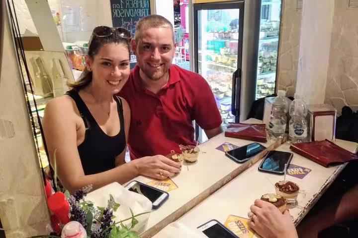 Happy couple enjoying tiramisu desserts at a Rome café during a guided tour of Pantheon and Navona