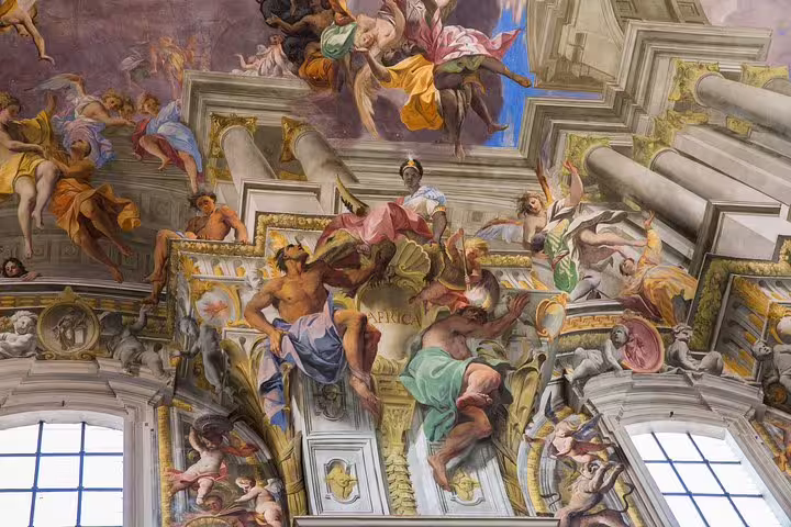 Vibrant frescoes in a Roman church ceiling, showcasing colorful figures and mythical scenes, perfect for family-friendly tours.