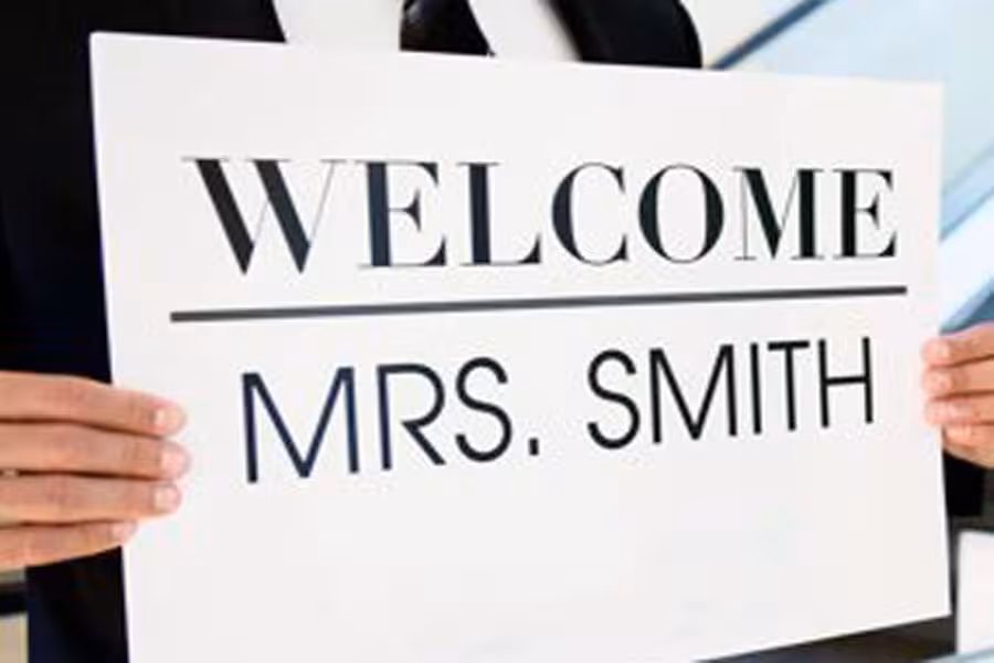 Close-up of a welcome sign with 'Mrs. Smith' for a private transfer service from Rome FCO.