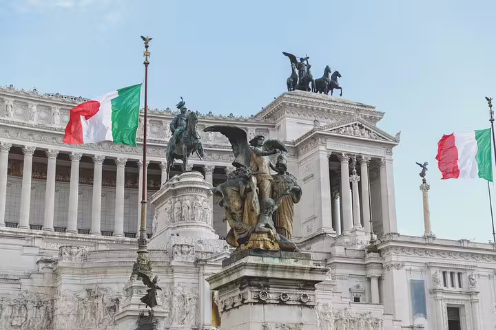 Italian flags wave at the majestic Altare della Patria in Rome, capturing the grandeur of iconic historical landmarks.