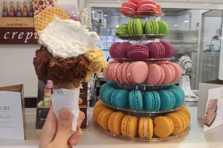 Delicious gelato cone and colorful macaron tower at a Rome dessert shop near Pantheon and Navona