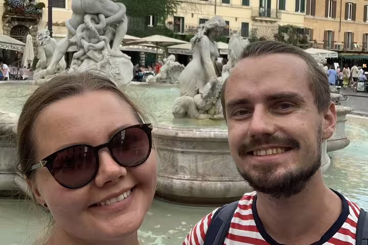 Couple smiling in selfie at Fontana del Moro, Piazza Navona, Rome