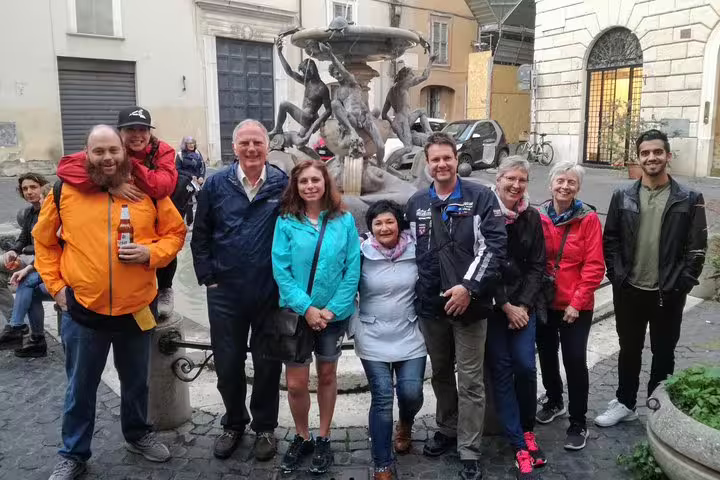 Happy food tour group posing by a fountain in Rome Jewish Ghetto near Pantheon on a walking tour