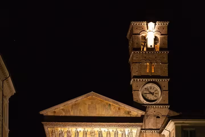 Illuminated facade of a historic Roman church at night, highlighting the Private Rome Night Craft Beer Walking Tour.