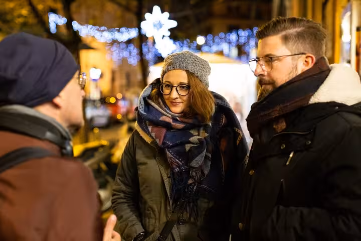 Tour group enjoys a night walk through illuminated Rome streets on a craft beer tasting journey.