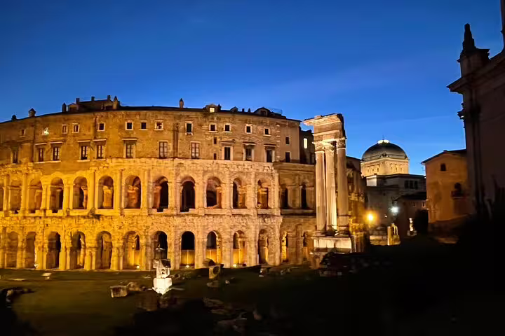 Illuminated ancient ruins of Rome at dusk viewed on a private chauffeured night tour with hotel pickup and drop-off