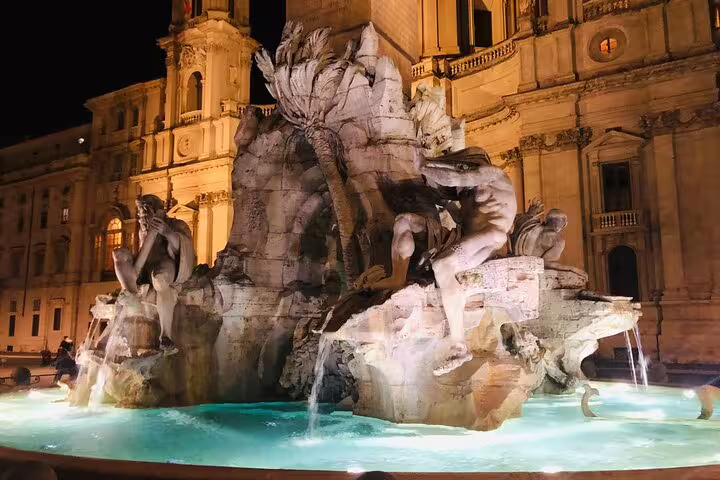 Illuminated baroque fountain in Piazza Navona captured on a Rome by night private chauffeured sightseeing tour