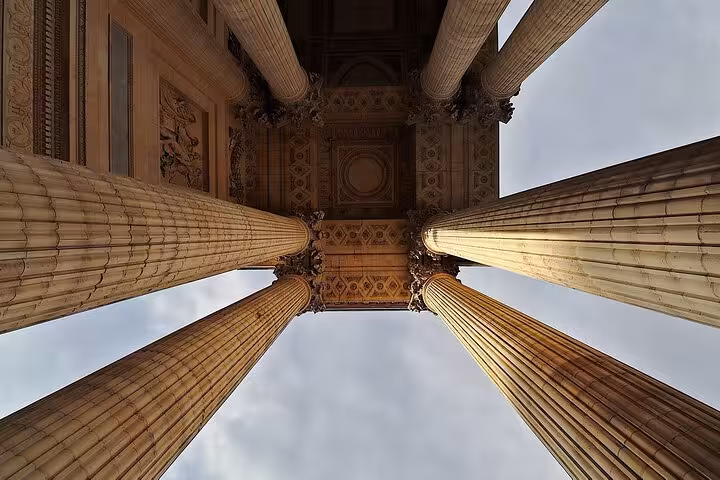 Upward view of majestic columns at Rome's Pantheon, highlighting its grand architectural elegance.