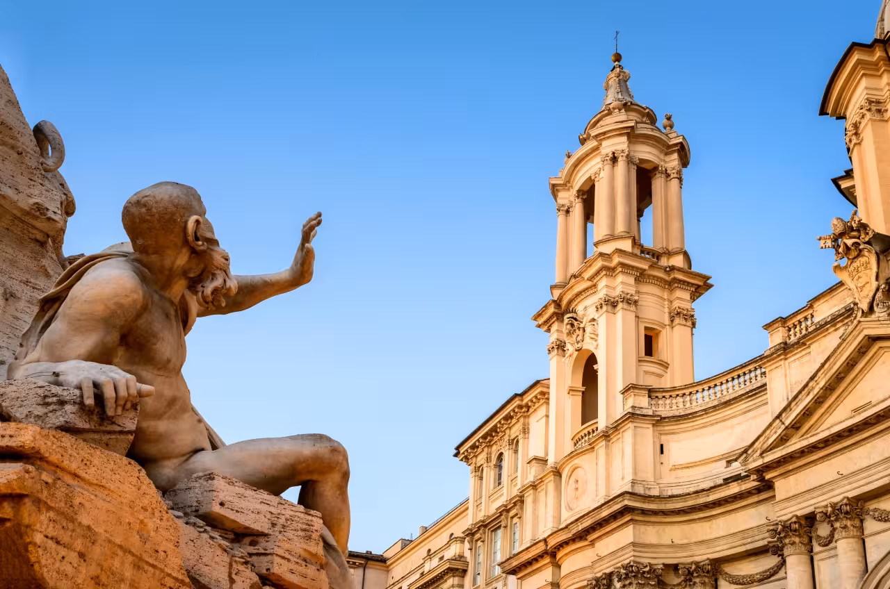 Fountain statue and Sant’Agnese in Agone facade, Piazza Navona stop on Rome Ancient Amusement Tour guided walk