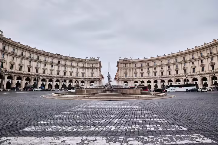 Piazza della Repubblica in Rome with ornate fountain and curved neoclassical buildings under overcast sky