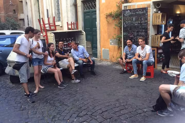 Group enjoying craft beer in Rome's Pigneto district, capturing the vibrant social scene and local culture.