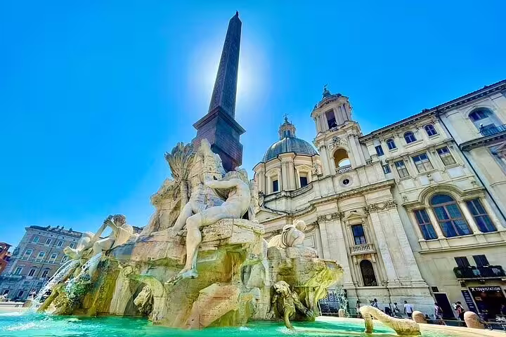 Fontana dei Quattro Fiumi and Egyptian obelisk in Piazza Navona on a sunny day during a private Rome city tour